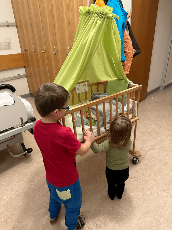 three siblings in the hospital holding hands
