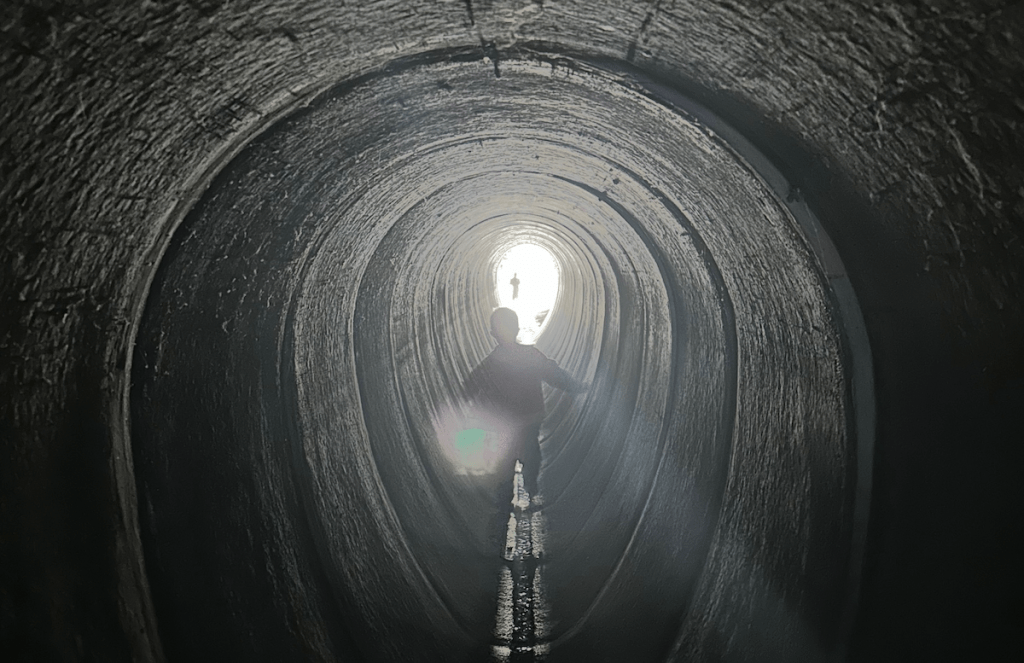 Boy in the dark tunnel