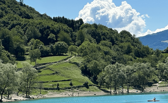 Lake Tenno with mountains and white clouds